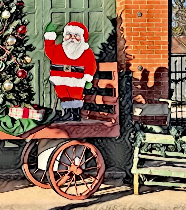 Detail of puzzle image highlighting Santa waving from red wagon in front of green dooe and red brick. Green christmas tree with red and white ornaments to the left of Santa