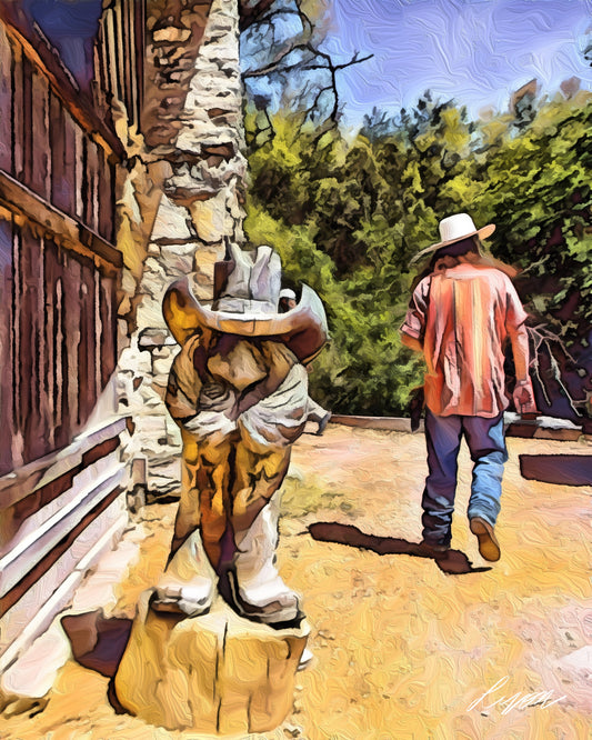 A carved wooden cowbot with oversized mustache, boots and hat between old wood and stne structure and real cowboy walking with his back to the viewer 